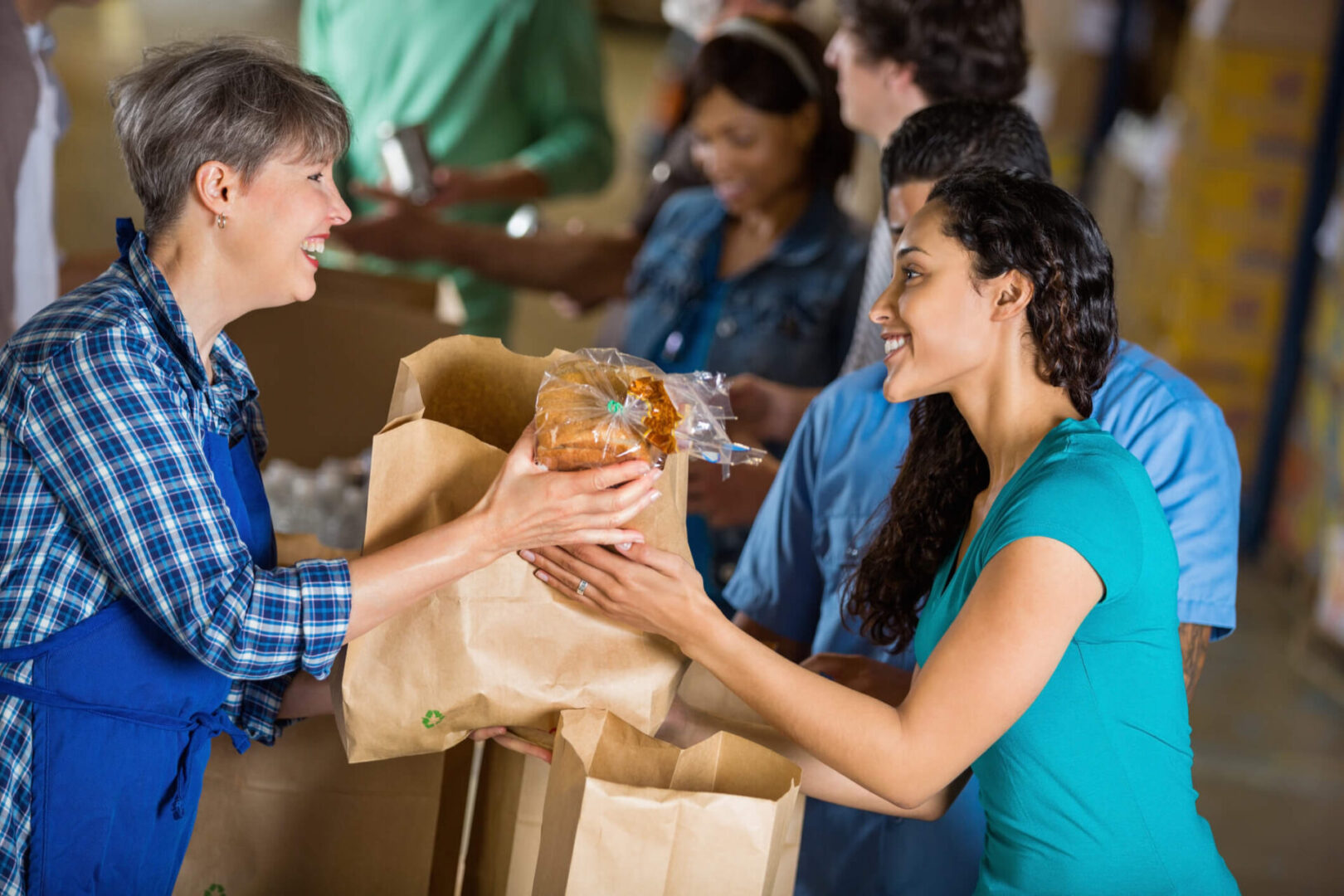 People exchanging groceries at food bank.