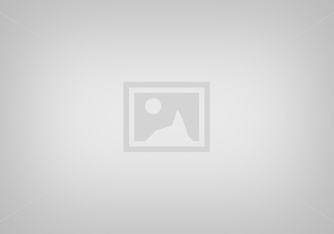 A modern kitchen with white cabinets and a large island.