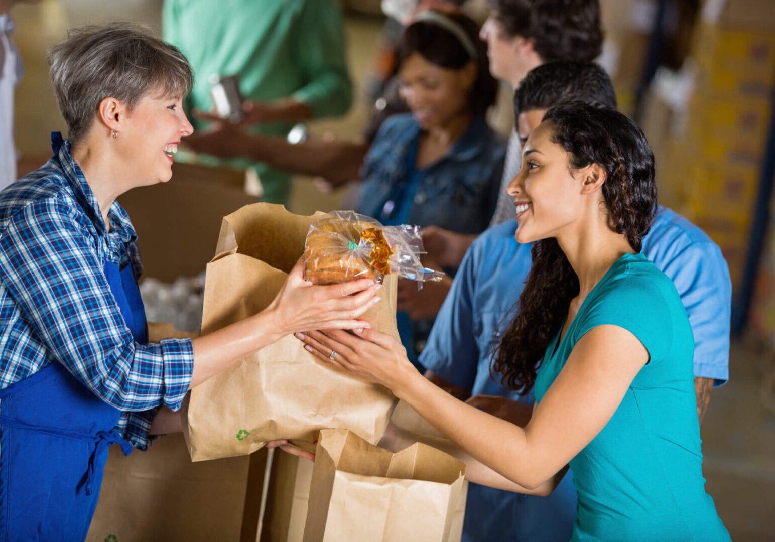 People exchanging groceries at food bank.